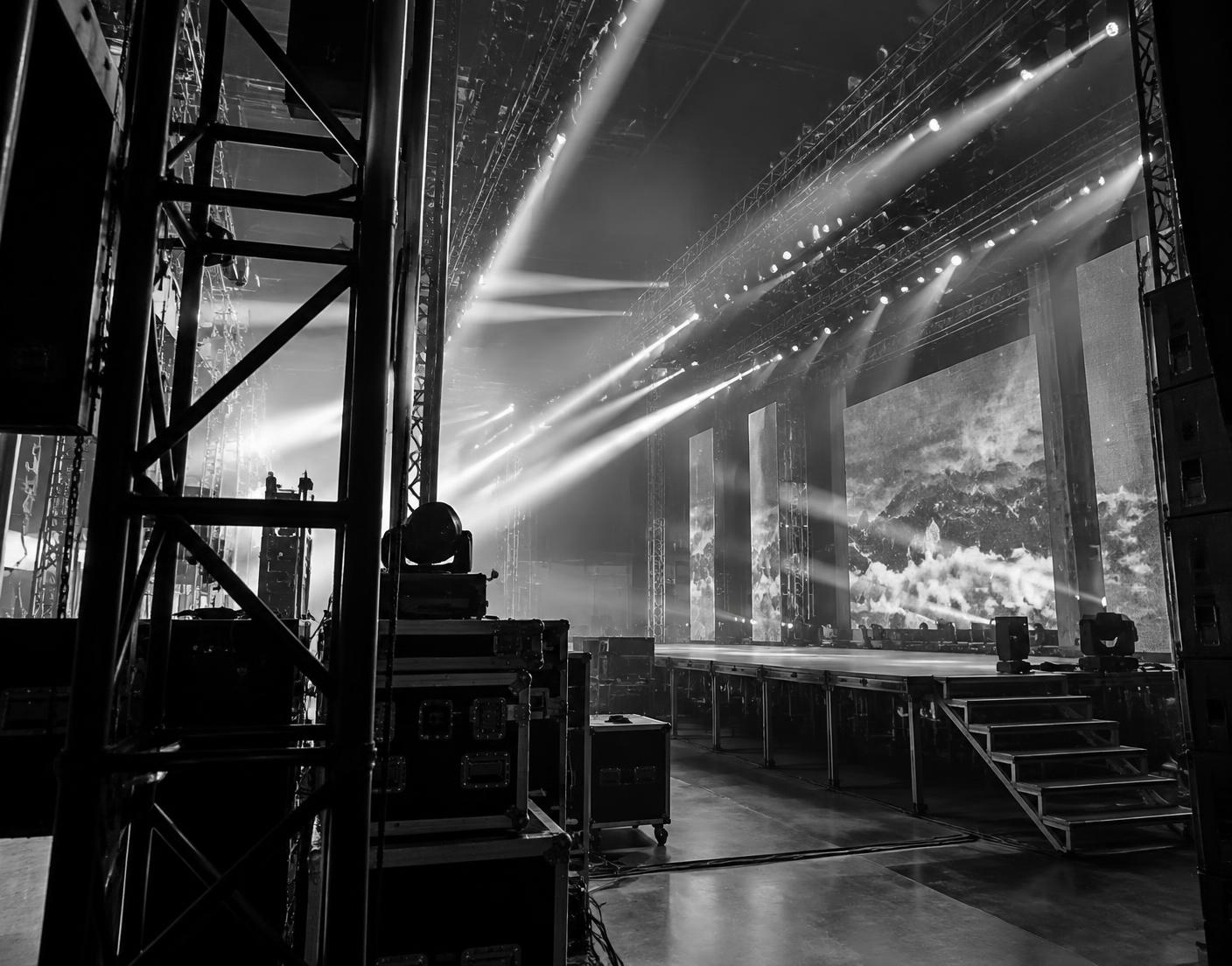 Stage lighting rig cutting through haze